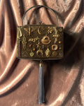 Gold mesh tasseled Gathered Charm Bag adorned with antique brass charms and collected vintage details.